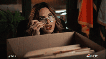 Olivia Benson from Law and Order taking her glasses off and gasping