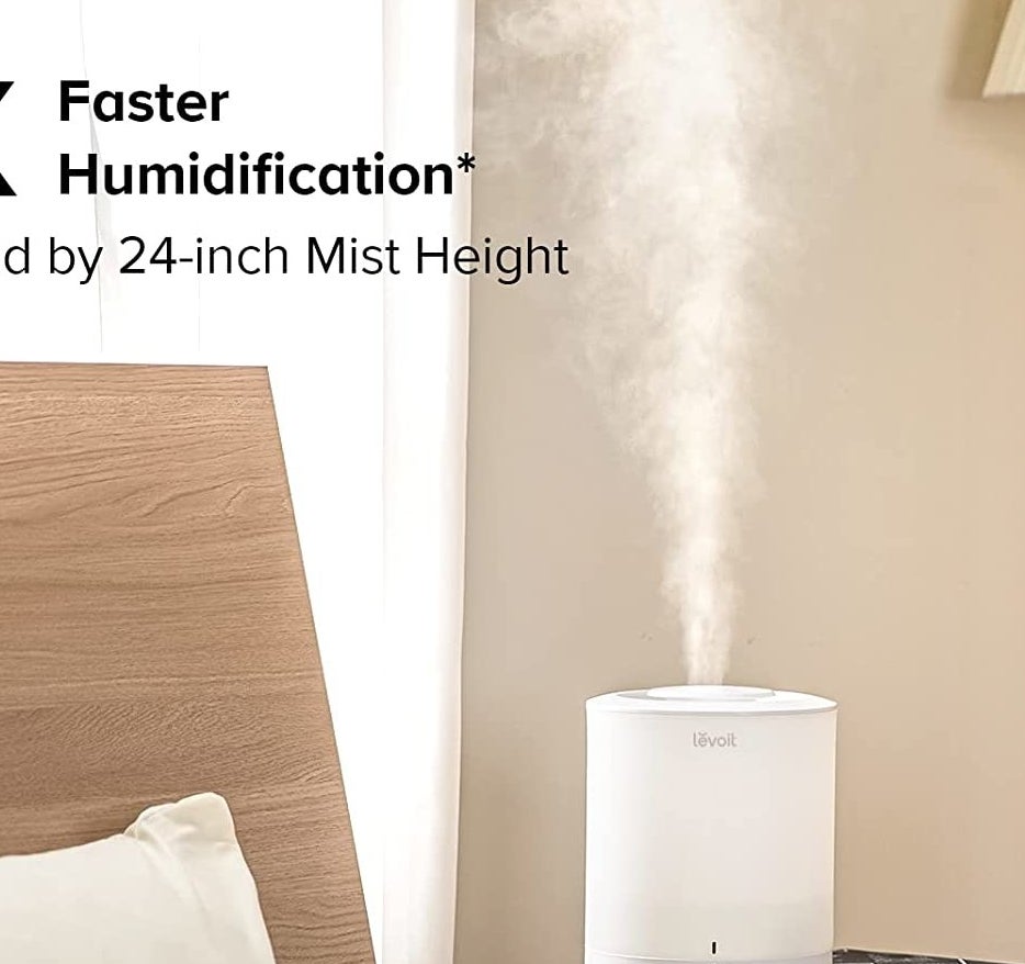 the humidifier on a side table blowing mist