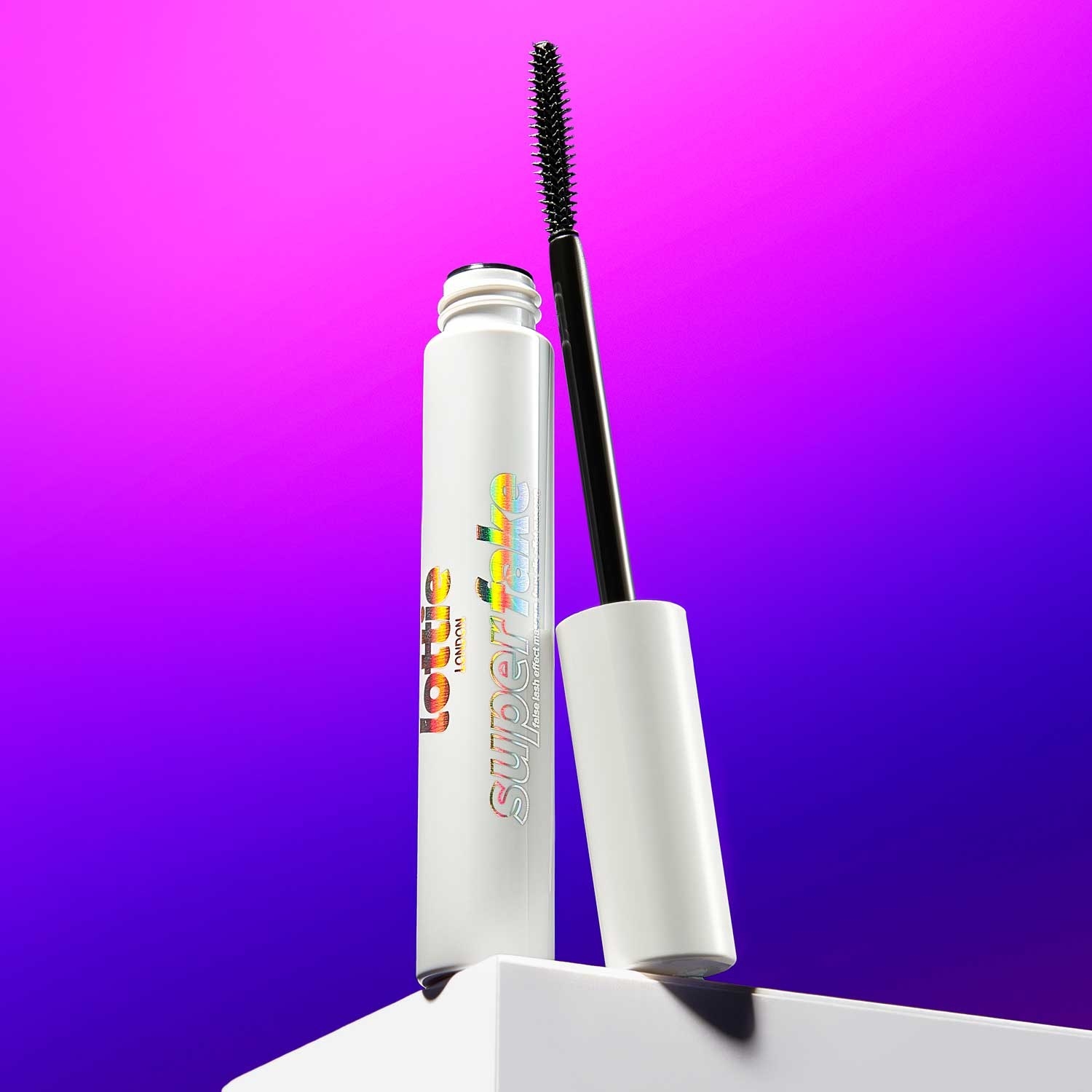 the mascara on a stand in front of a gradient backdrop