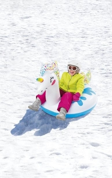 a kid riding the unicorn tube