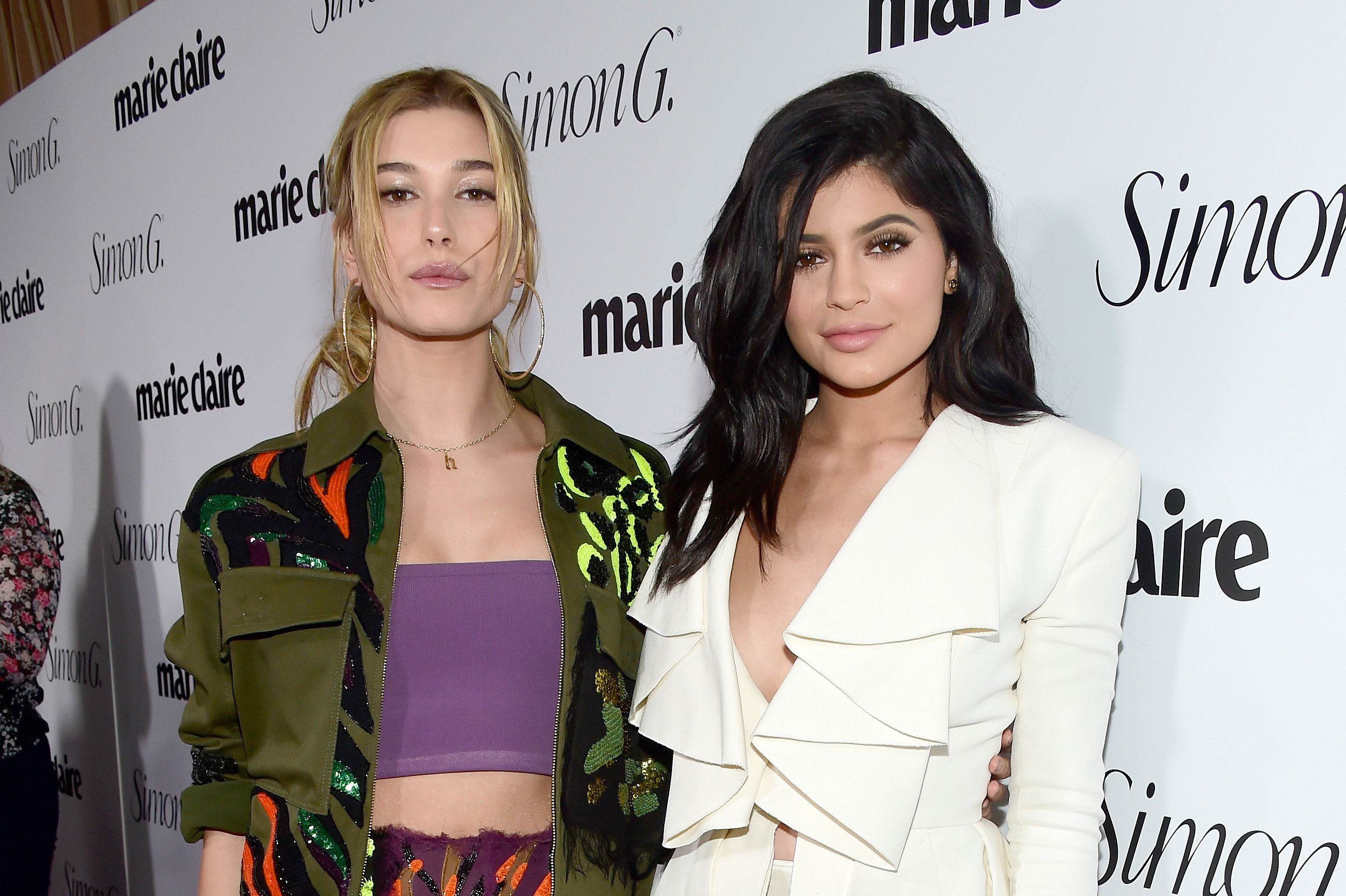 Hailey and Kylie with their arms around each other as they have their photo taken on the red carpet