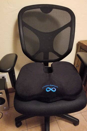 the black memory foam cushion on an office chair