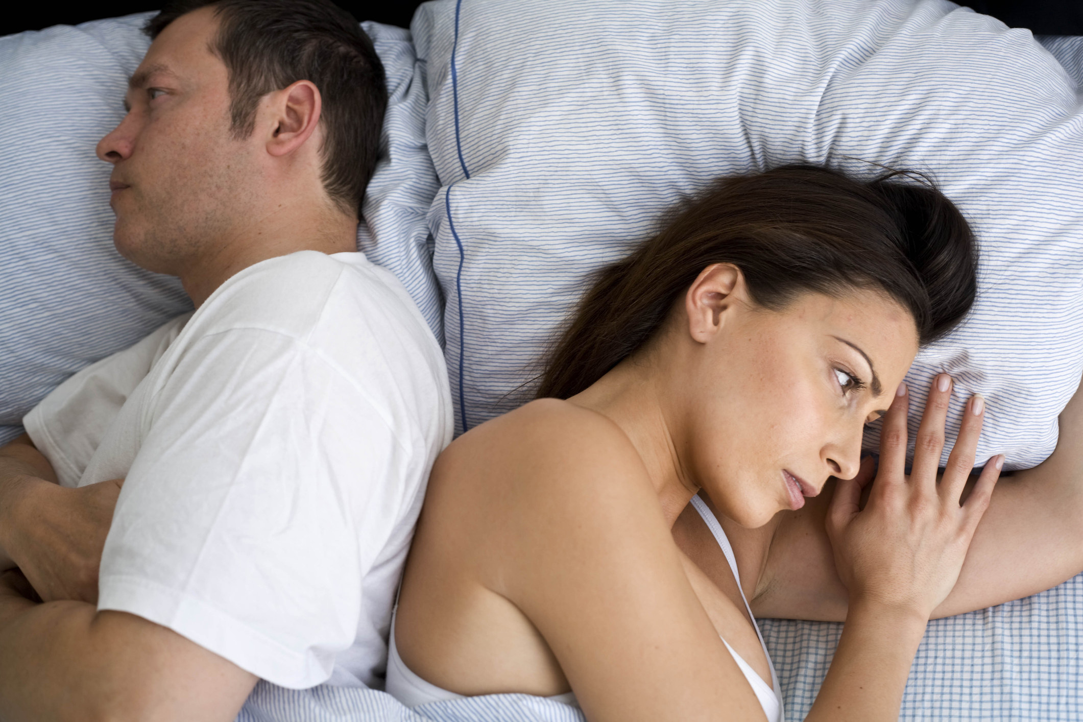 Couple not facing each other in bed