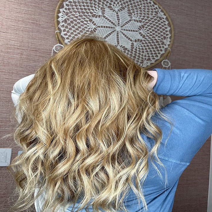 reviewer with wavy hair after using the leave in