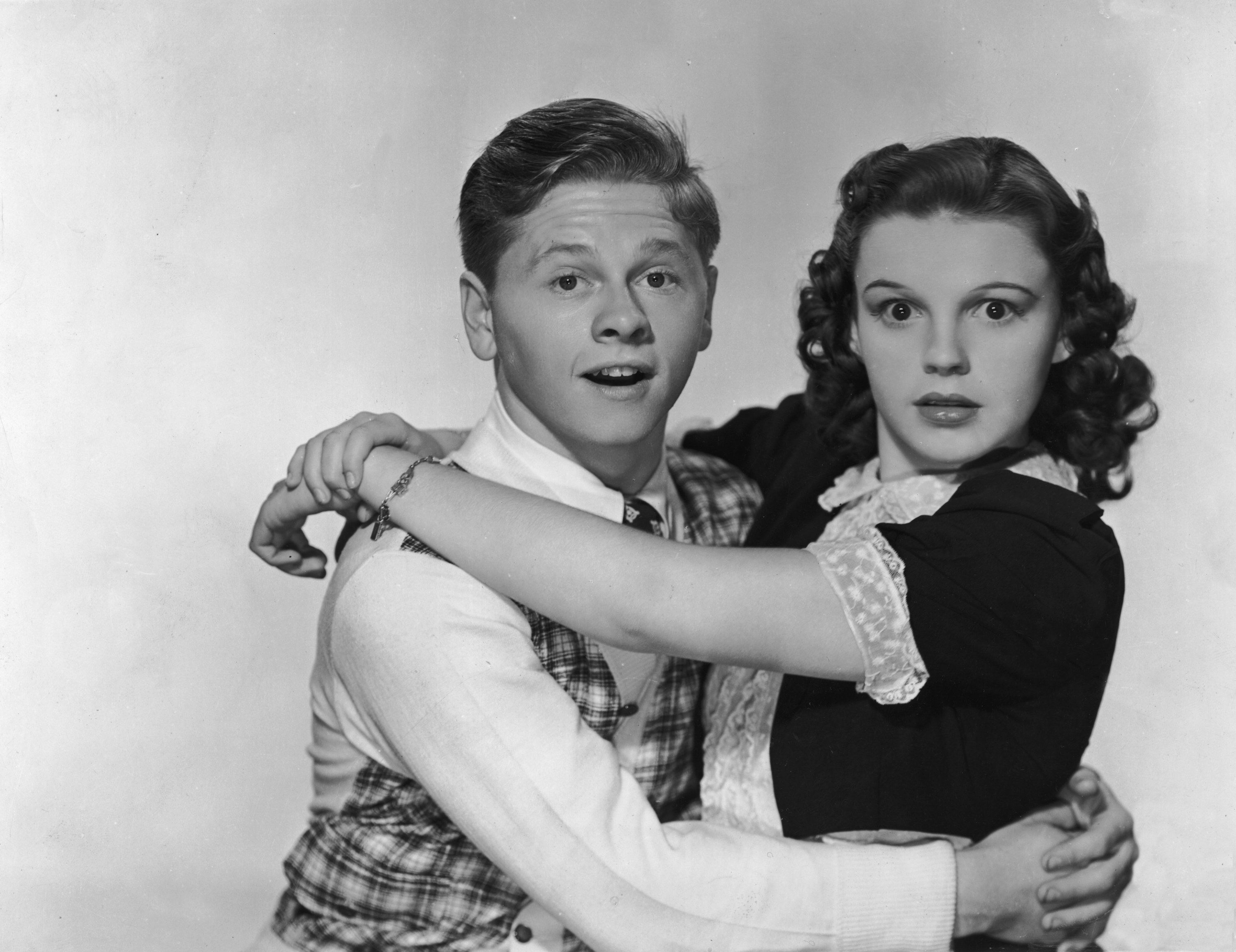 American actors Mickey Rooney and Judy Garland hug and look at the camera with surprised expressions, in a promotional portrait for director George B. Seitz&#x27;s film, &#x27;Love Finds Andy Hardy&#x27;
