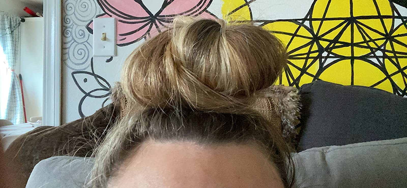 reviewers hair in a bun using the ponytail holder