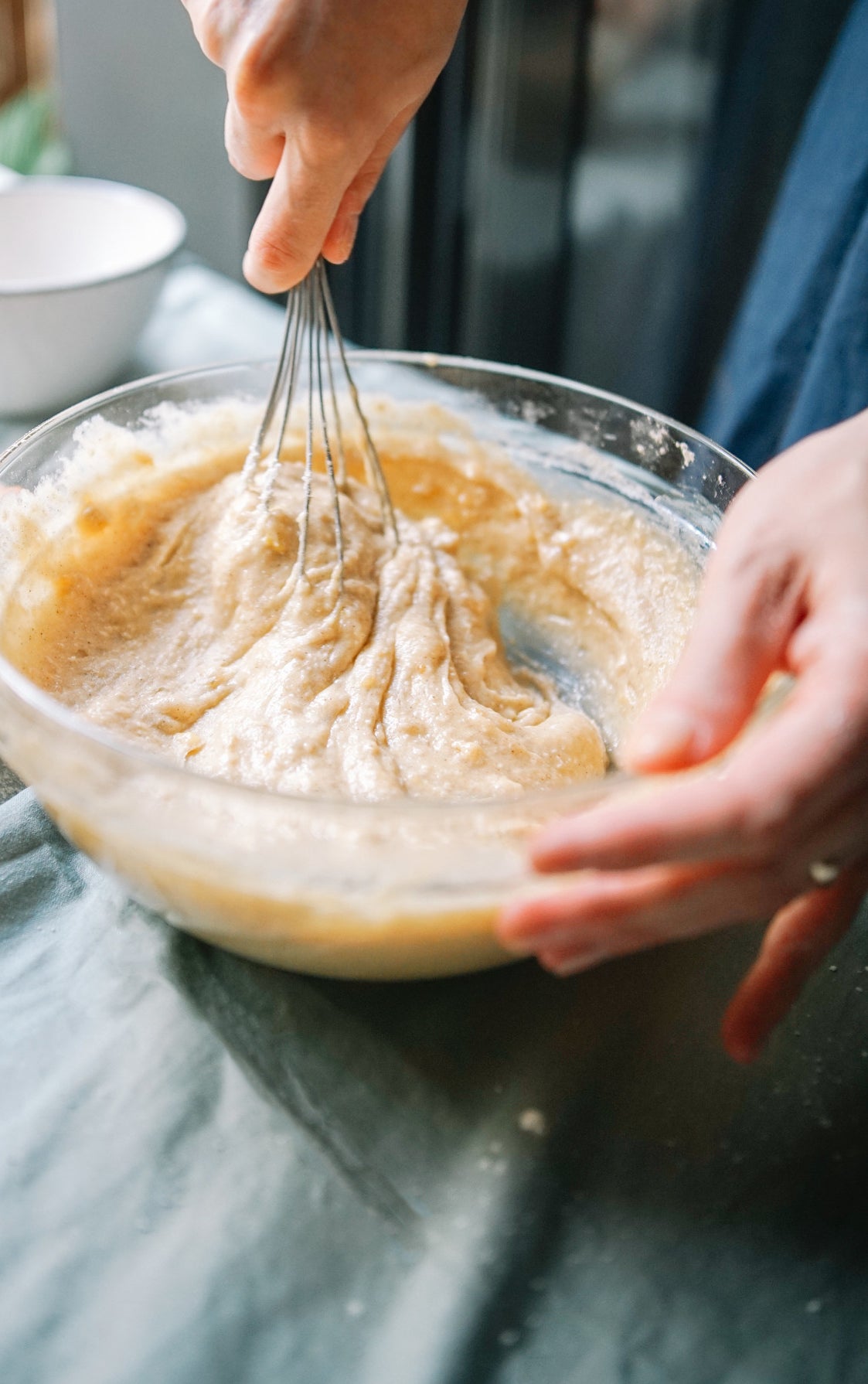 A woman whisking cake batter.