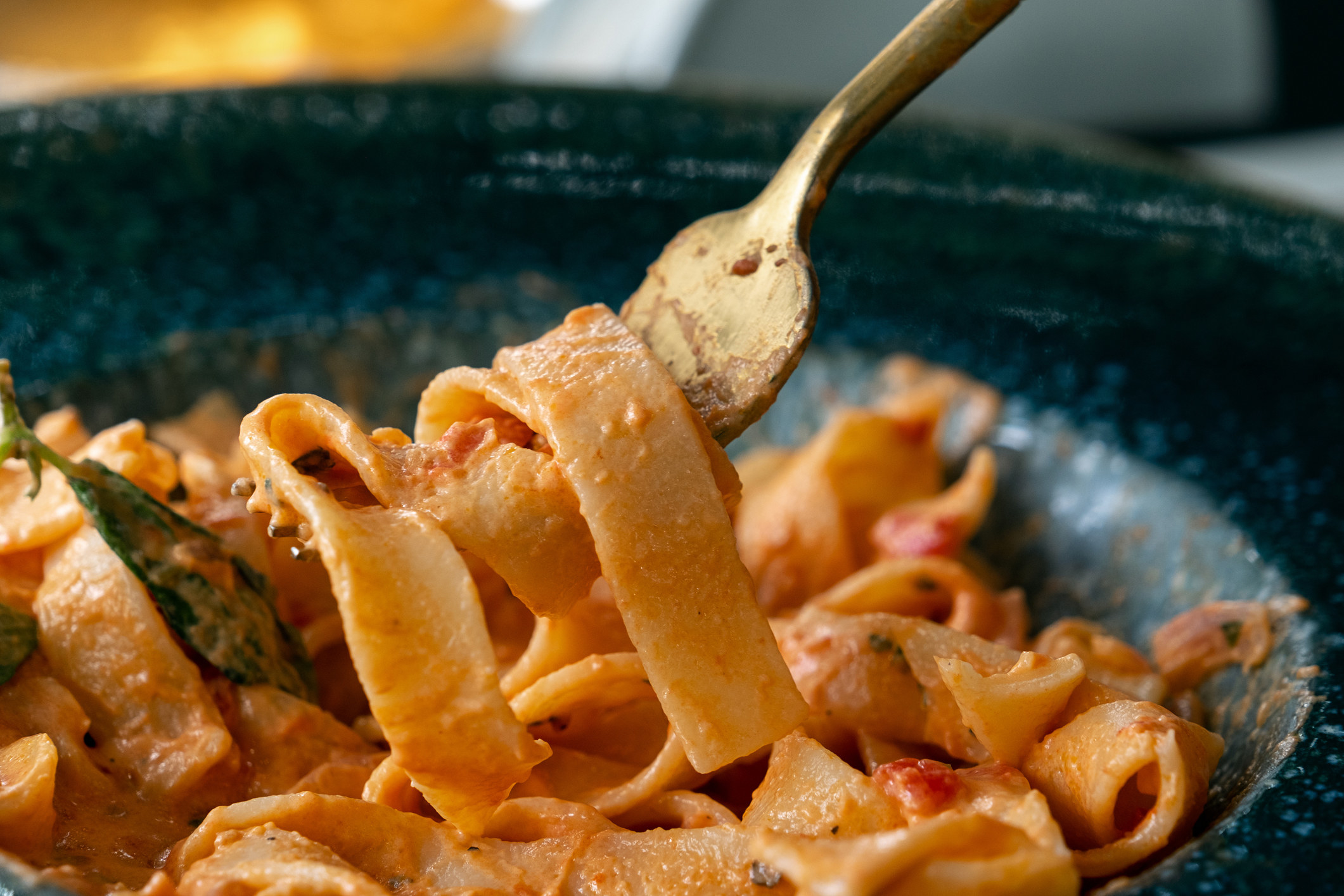A forkful of pasta in tomato sauce.