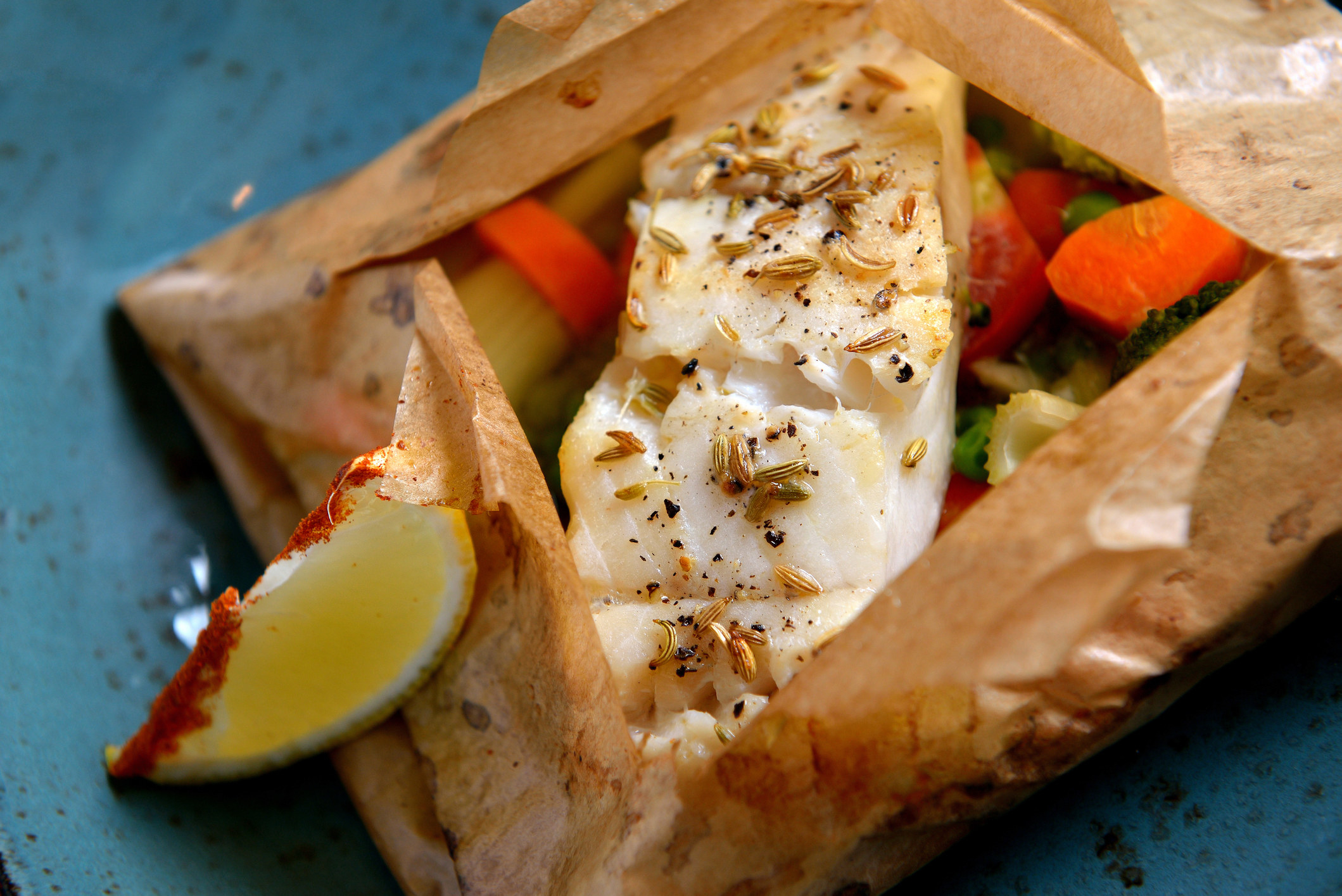 White fish fillet baked in paper.