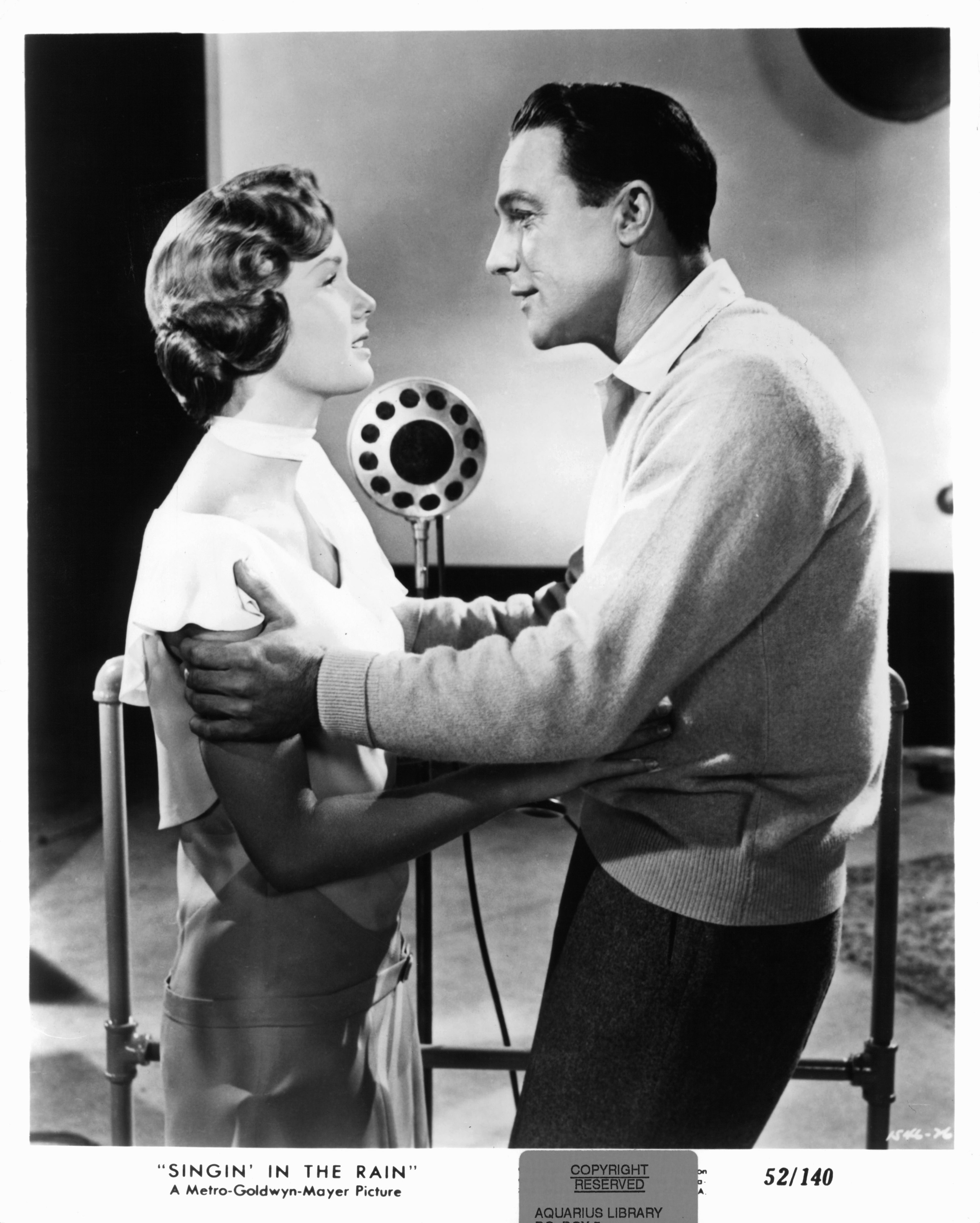 Debbie Reynolds holds Gene Kelly in a scene from the film &#x27;Singin&#x27; In The Rain&#x27;, 1952