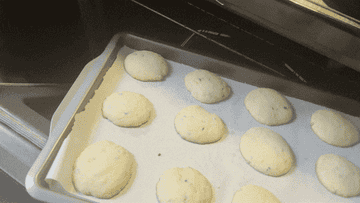 author pulls the pan with cookies out of oven