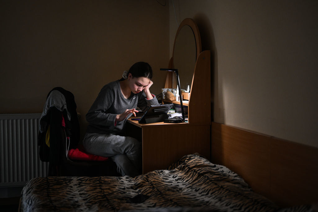 Juliana, age 14 from Dnipro Oblast attends an Ukrainian online class at the Green Hotel on February 23, 2023 in Jerzmanowice, Poland.