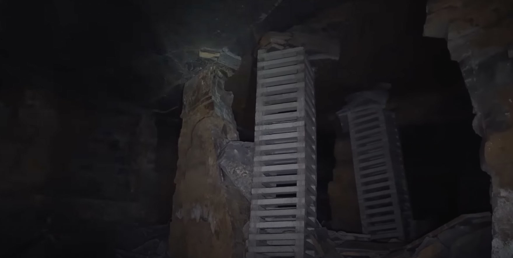 cement columns holding up the ceiling inside of a cave