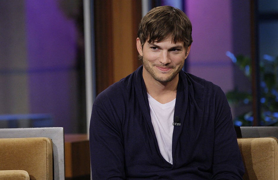 ashton kutcher smirking during an interview