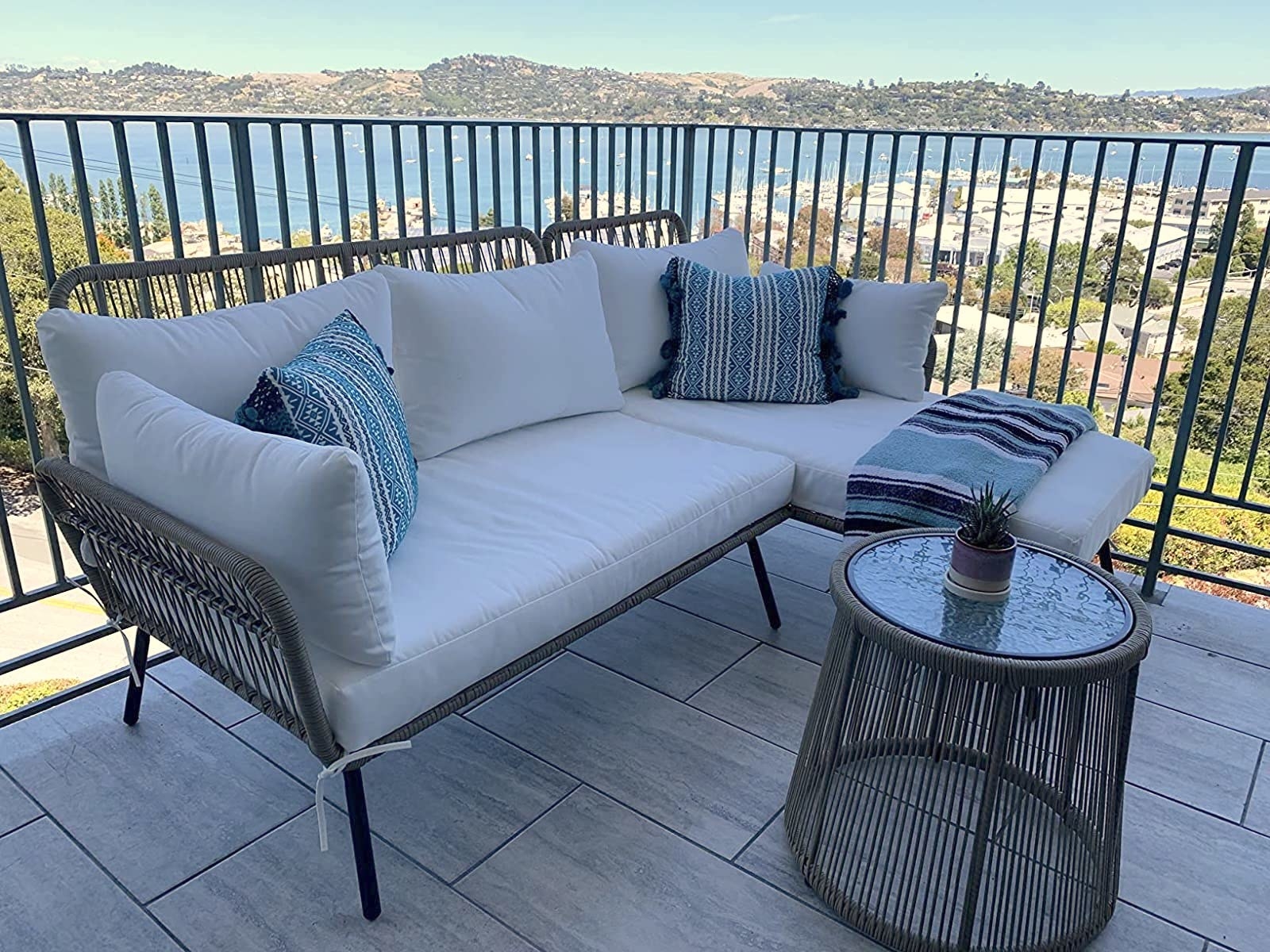 reviewer photo of a sofa chaise sectional and small table on a balcony