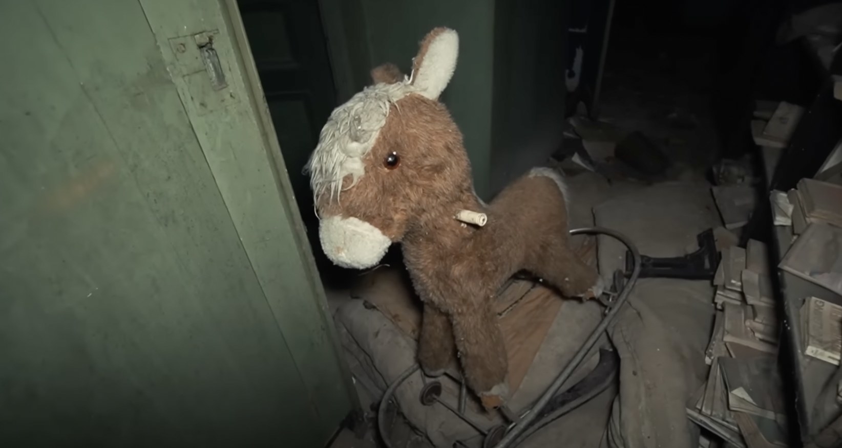 a rocking horse in an abandoned house