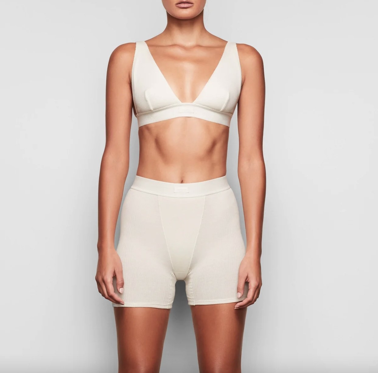 Reviewer wearing boxers in off white with matching bralette