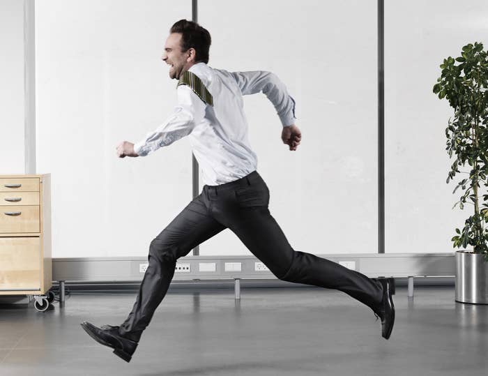 Man in office attire running