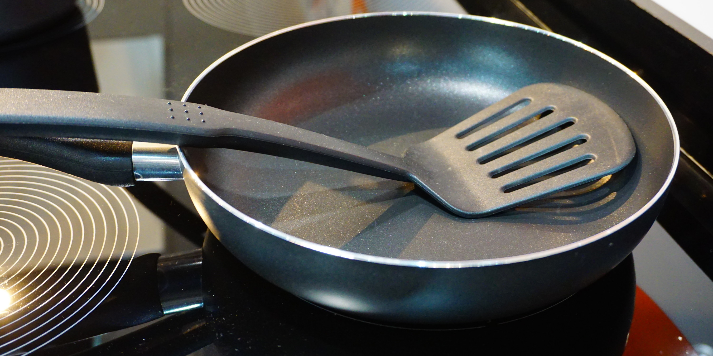 spatula in a crying pan on a stove top