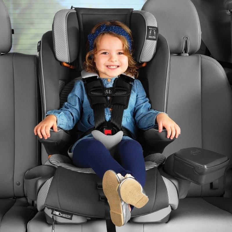 Child sits in car seat