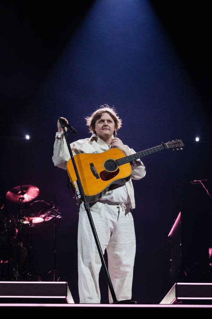 lewis on stage with a guitar