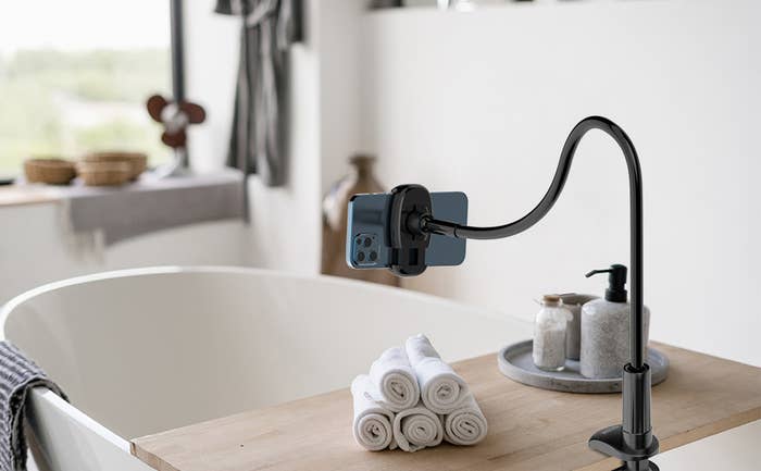 The phone mount attached to a bathtub
