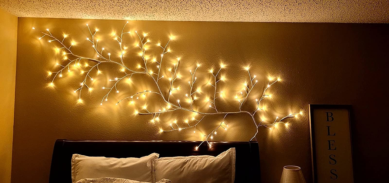 Vine lights hanging above a bed