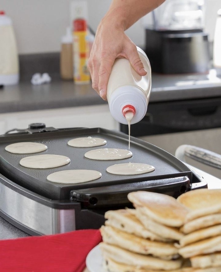 A person pouring batter onto a griddle