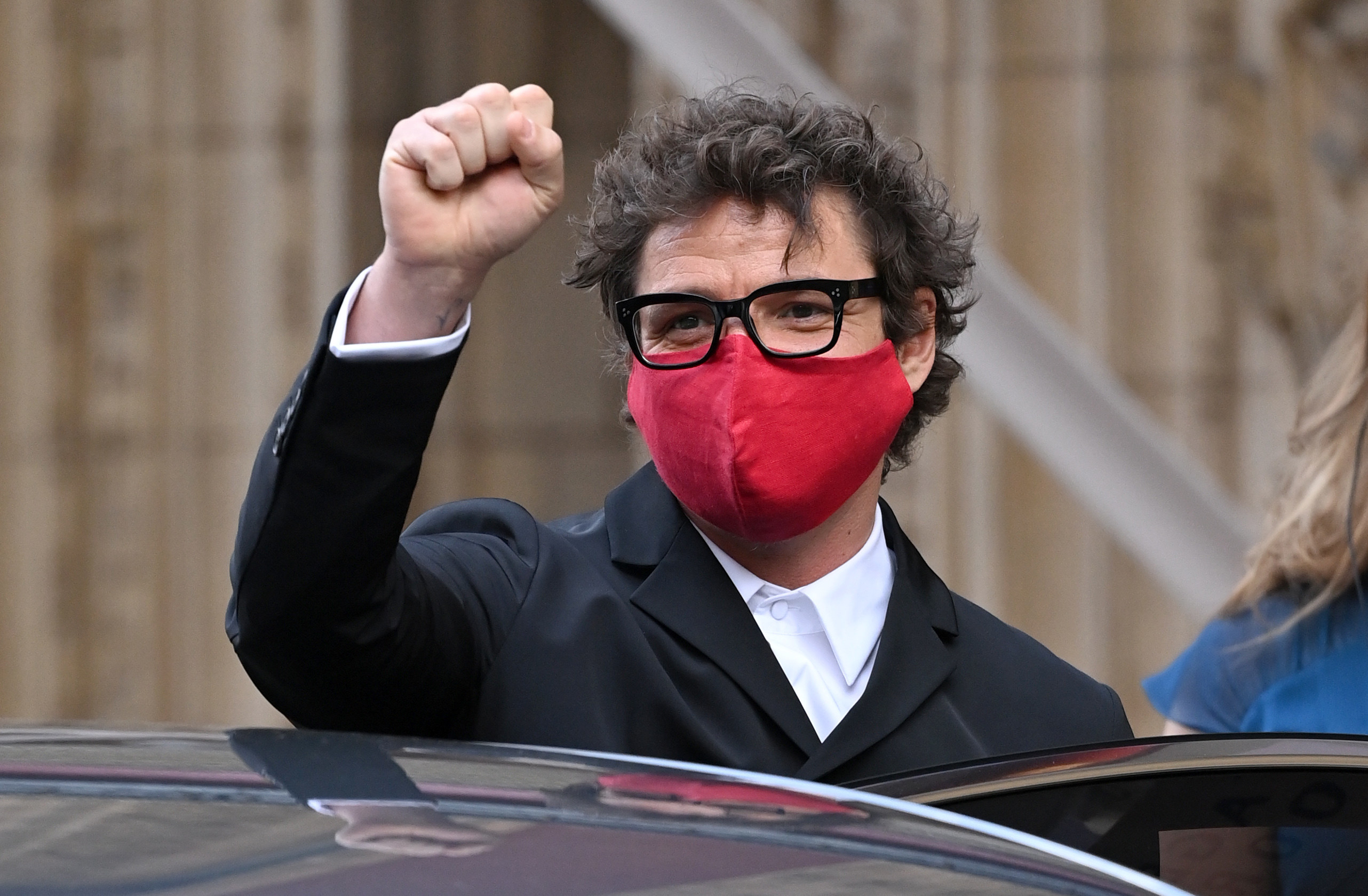 Pedro with raised fist and wearing a mask