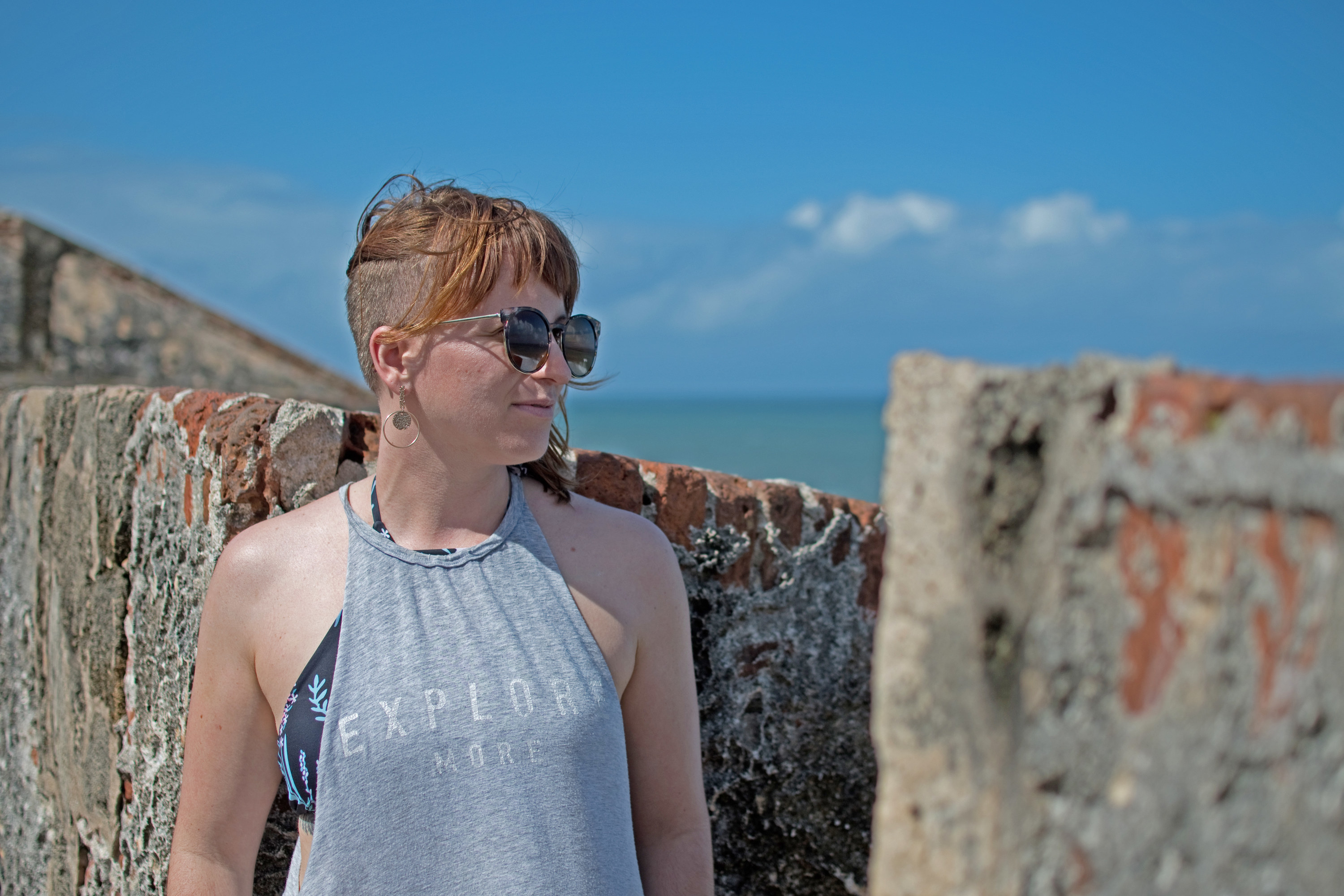 woman in Puerto Rico standing by bricks in the breeze