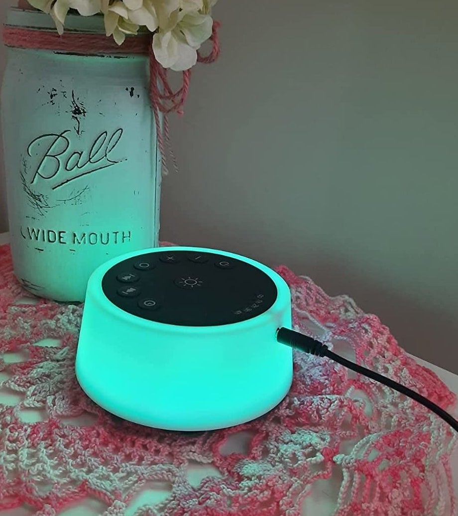 a reviewer photo of the sound machine glowing teal