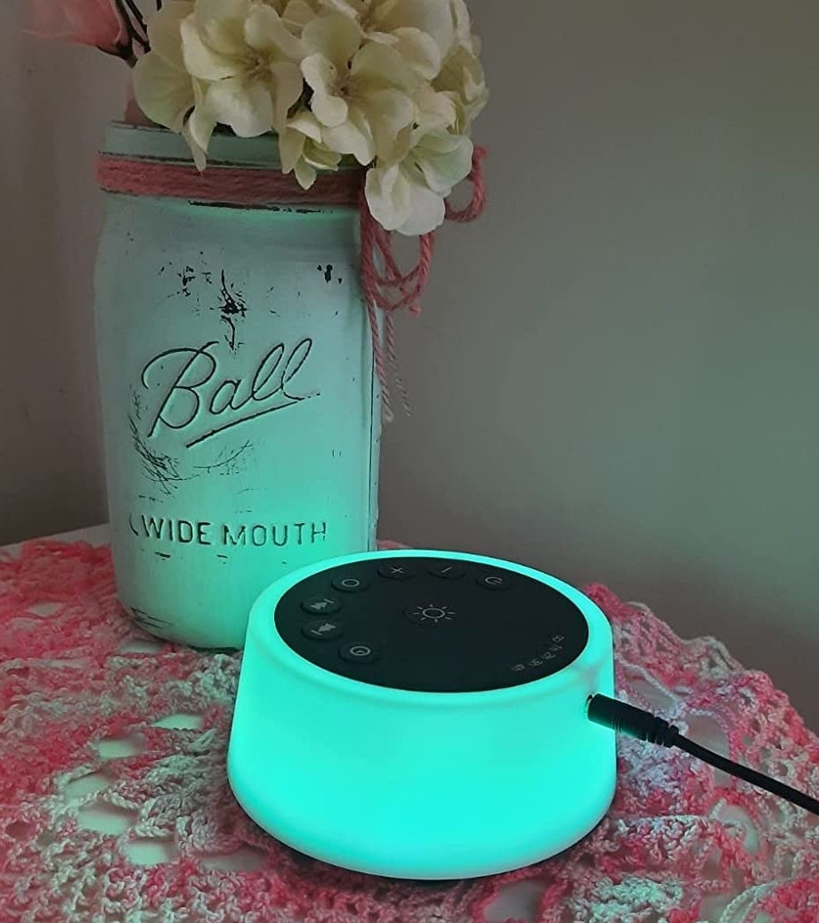 a reviewer photo of the sound machine glowing teal