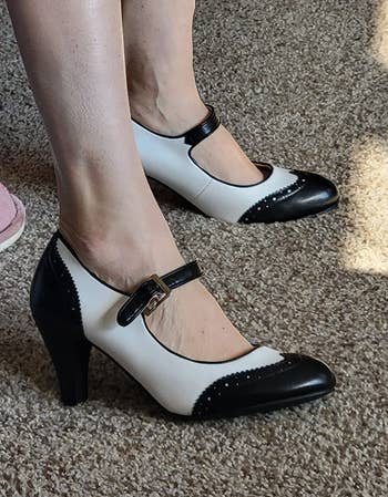 Reviewer wearing the black and white heels