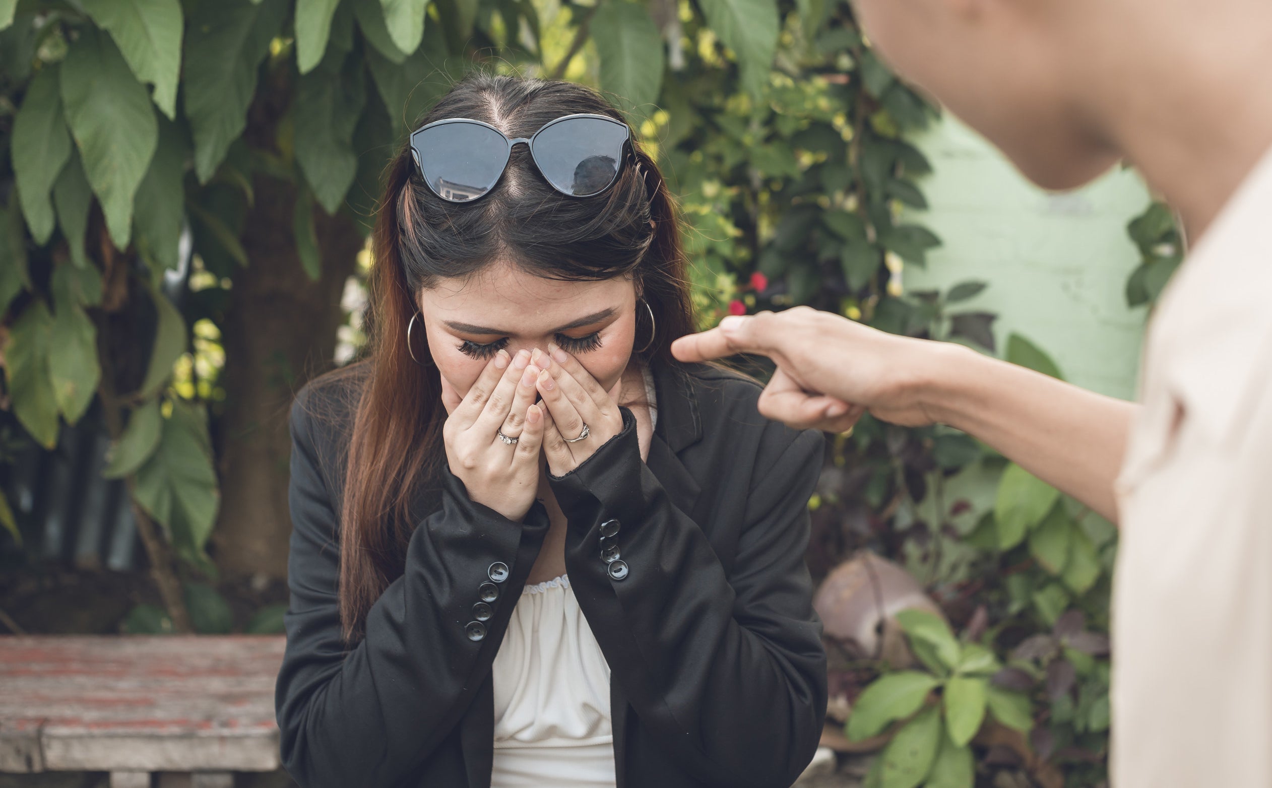 woman crying as man points finger close to her