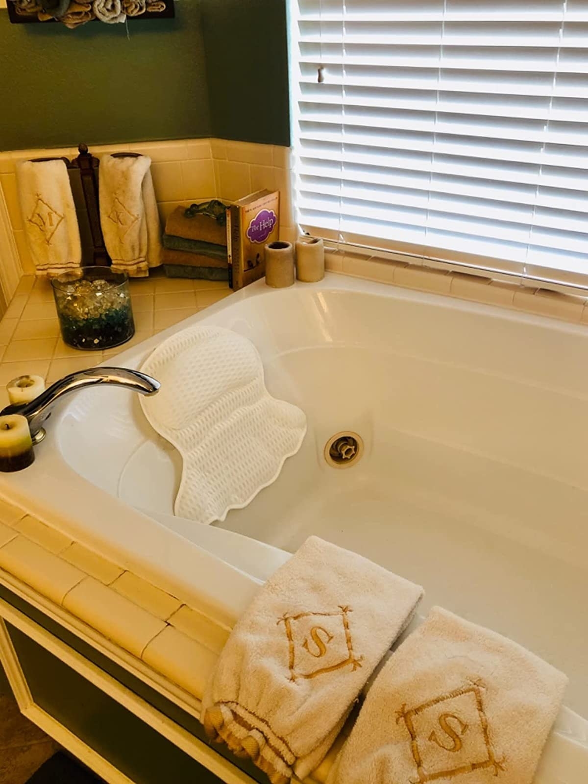a reviewer photo of the bath pillow in tub