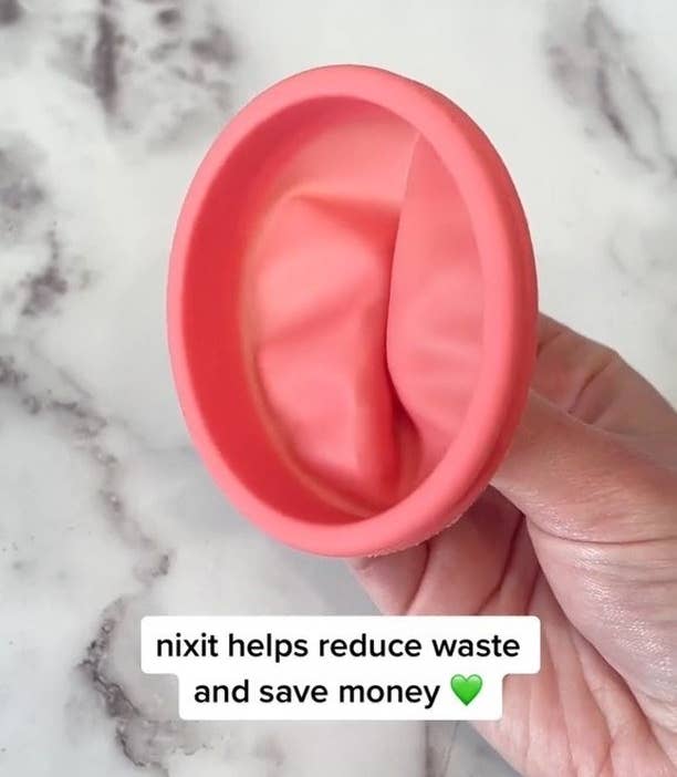 A person holding up a menstrual cups