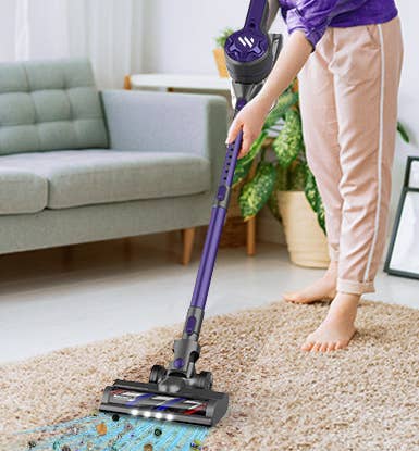 the vacuum cleaner shown extended and converted into a mini vacuum against a blank background
