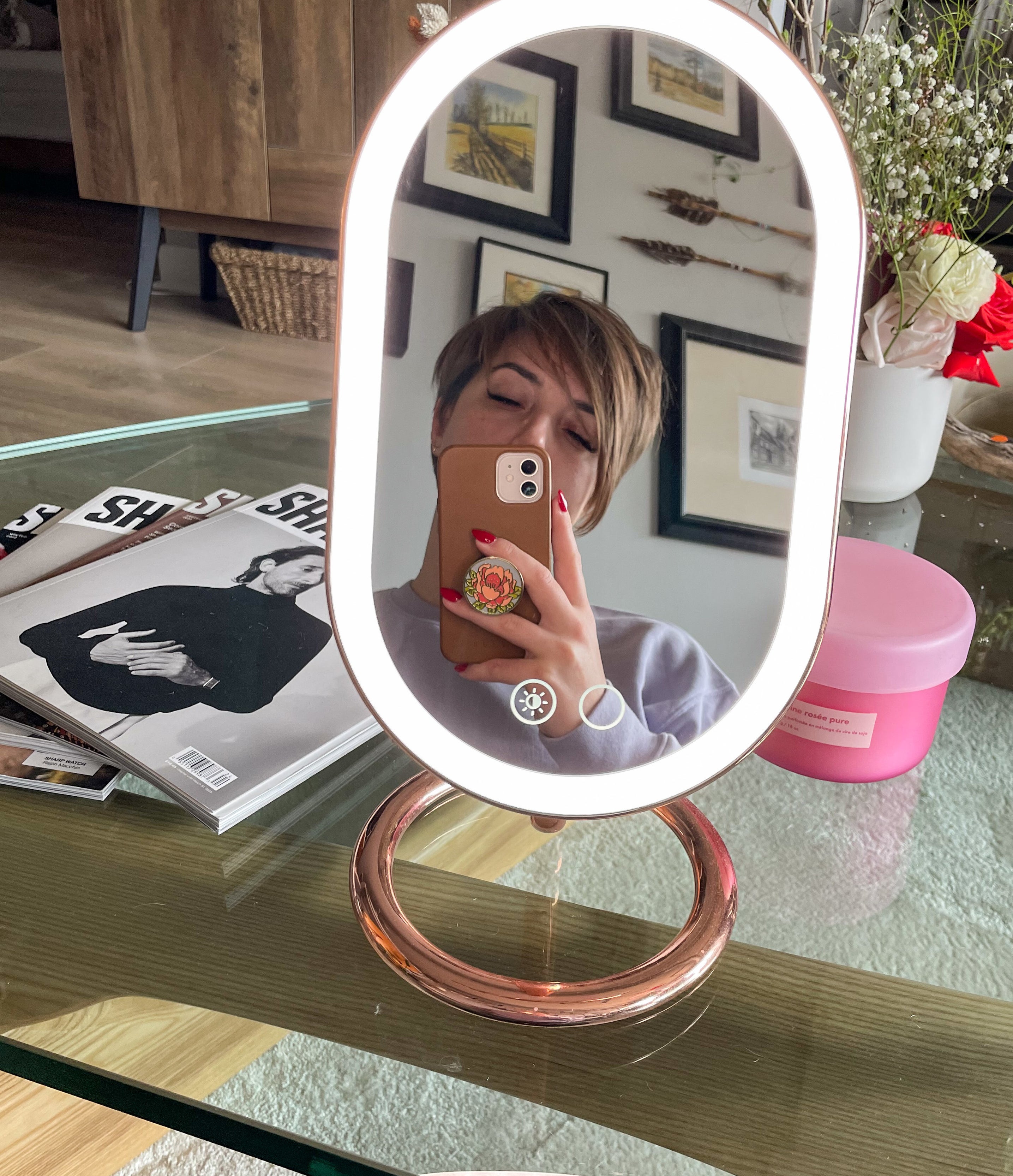 victoria taking a selfie in the backlit vanity mirror