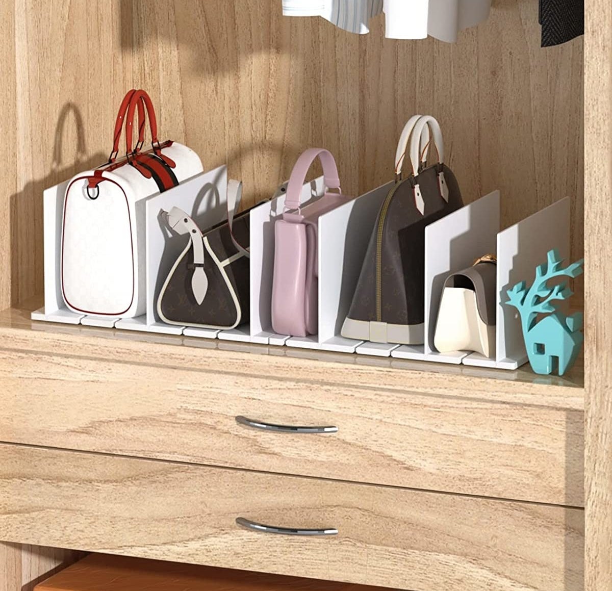 a set of adjustable shelf dividers holding a collection of purses