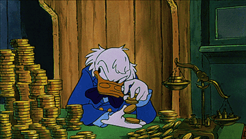 Scrooge McDuck plays with his many gold coins