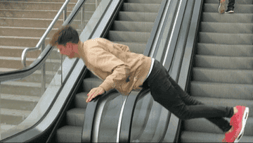 A man spinning on the escalator