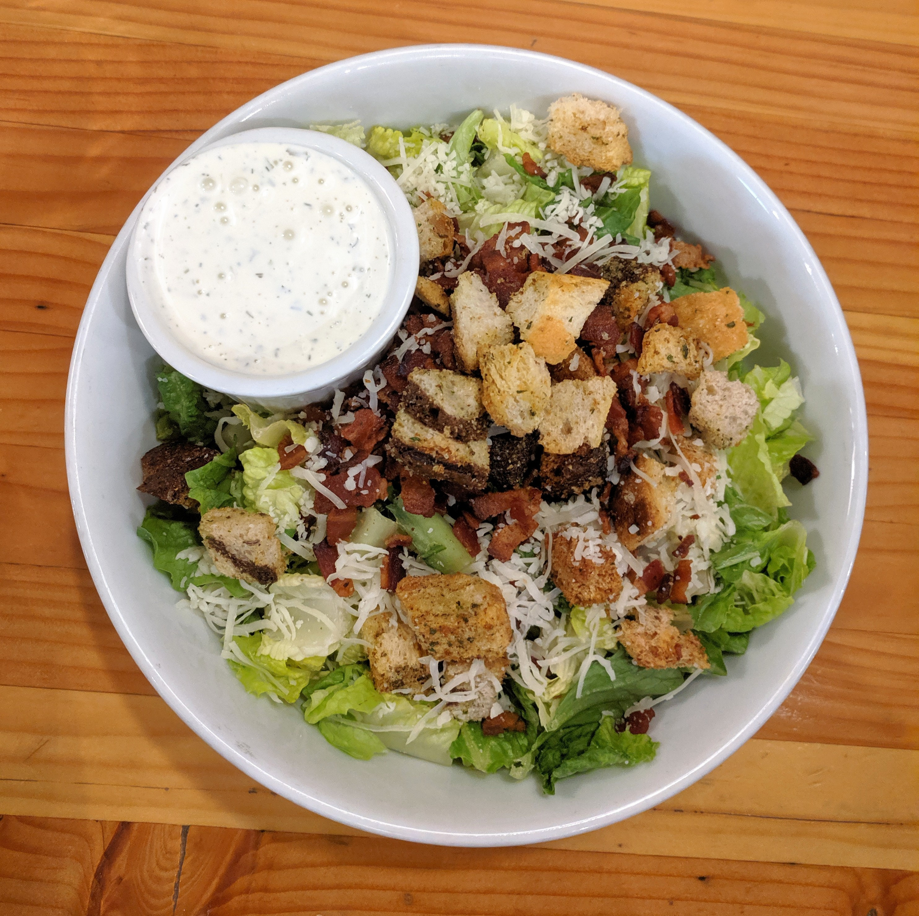 A salad with Ranch dressing.