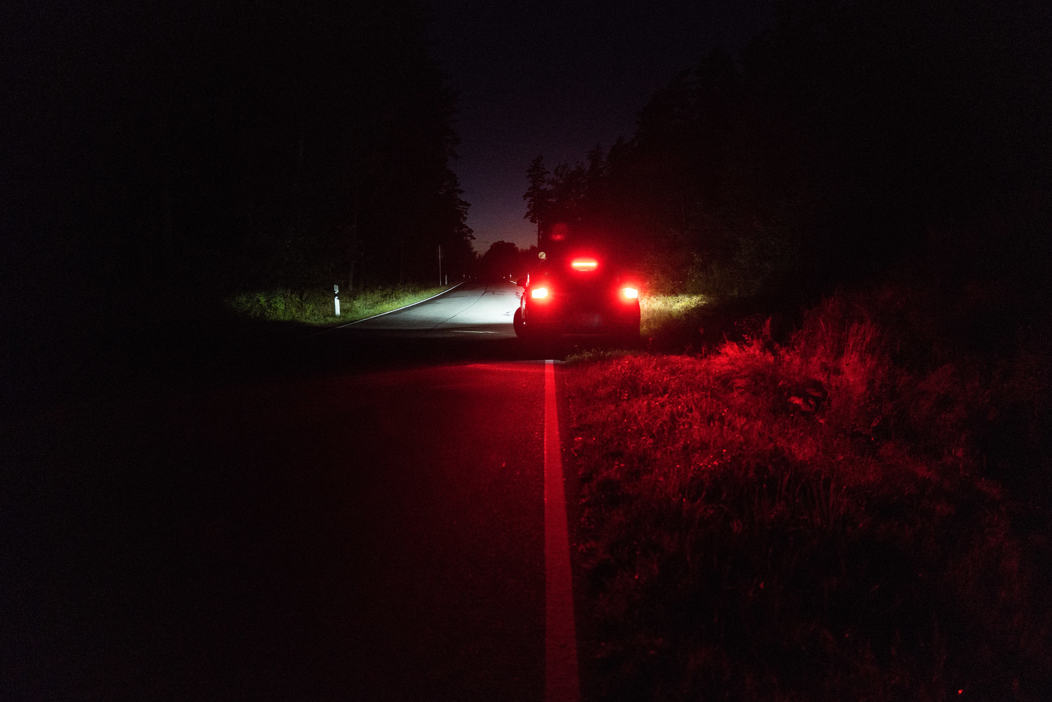 car pulled to the side of the road with its lights on