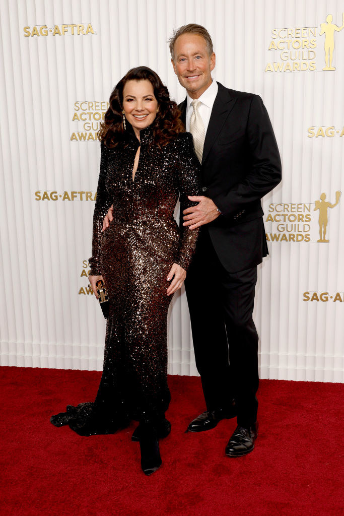 Fran Drescher and Peter Marc Jacobson smiling on the red carpet at the 29th Screen Actors Guild Awards