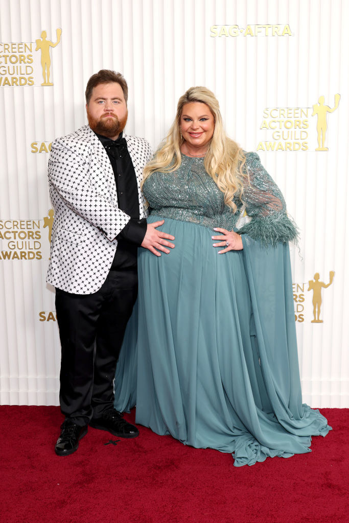 Paul Walter Hauser touching the belly of Amy Boland Hauser on the red carpet at the 29th Annual Screen Actors Guild Awards