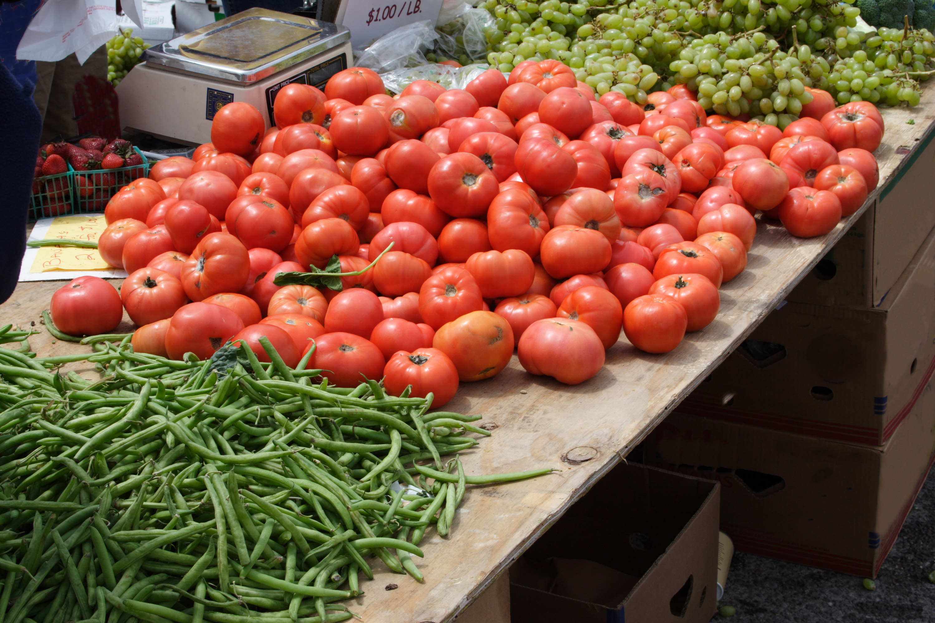 Fresh tomatoes and beans for sale at farmers market