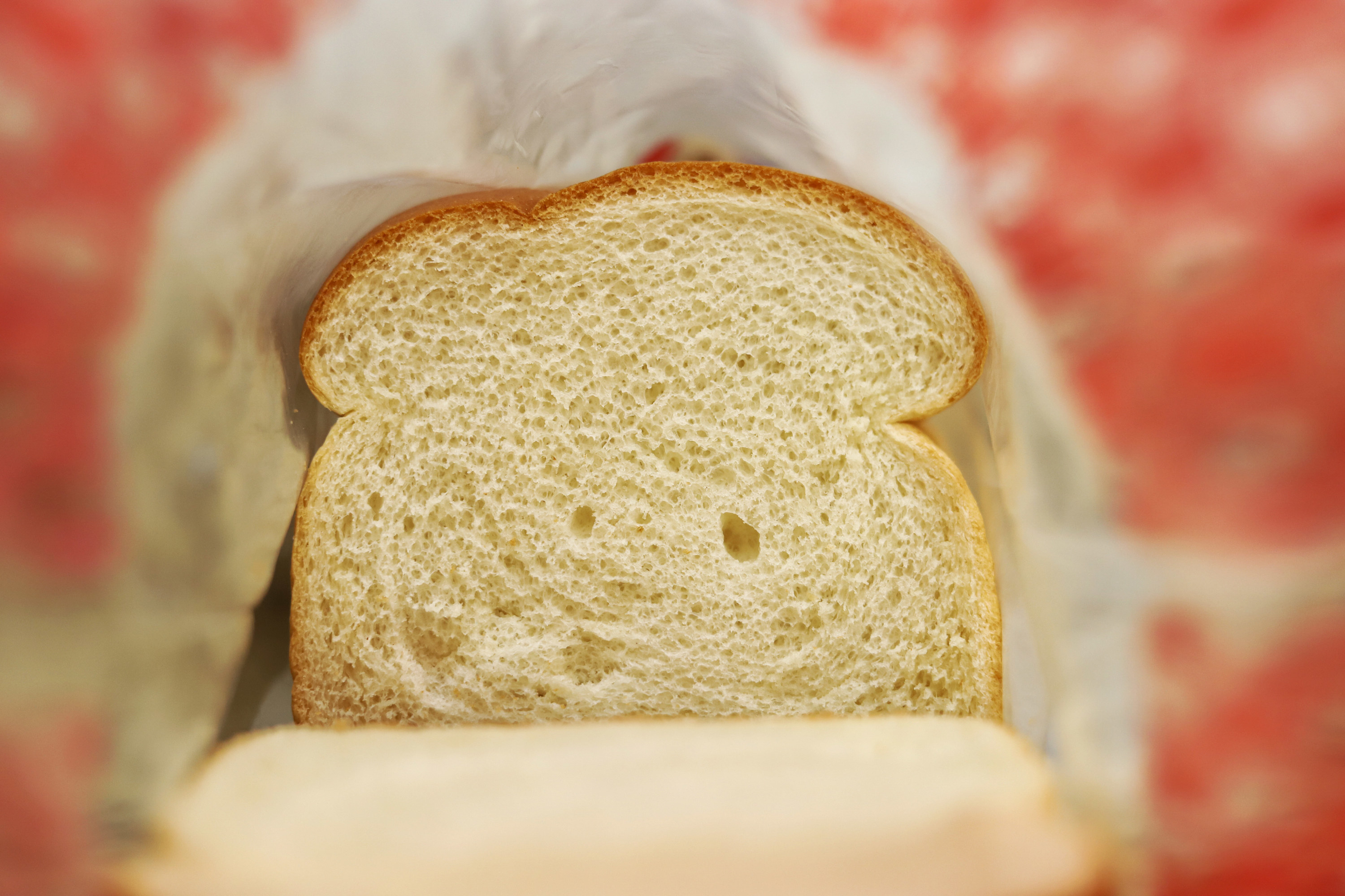 A close-up of a slice of white bread in a bag