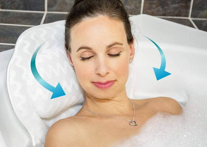someone using the bath pillow in a tub