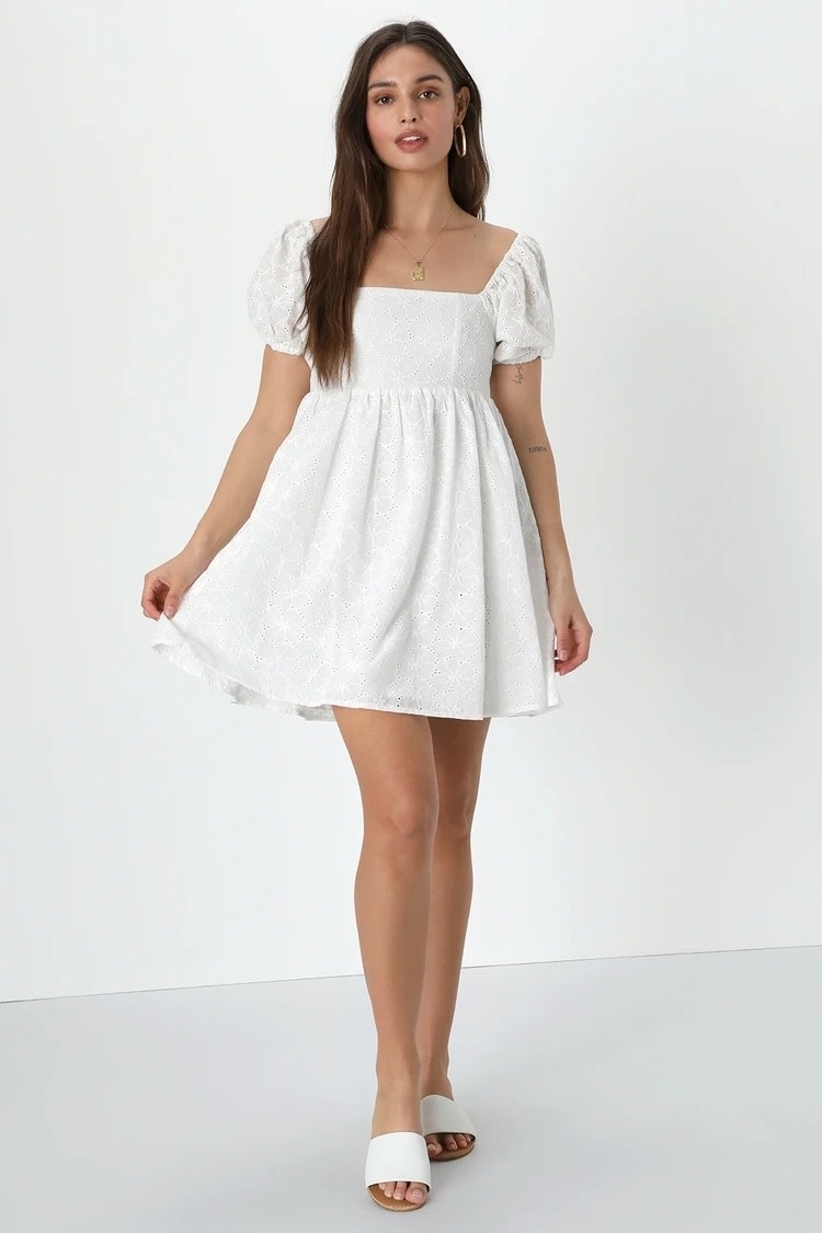 Model wearing white dress with white shoes