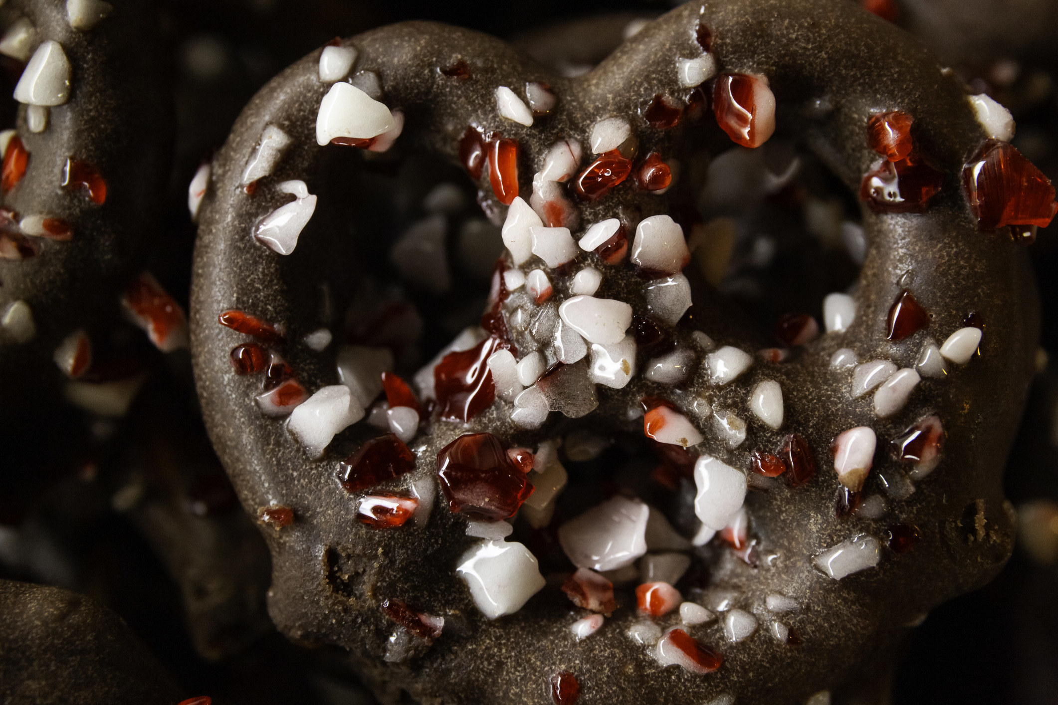 A close-up of a chocolate covered pretzel with peppermint.